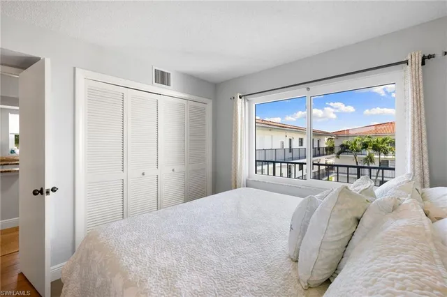 a bedroom with a large bed and a large window