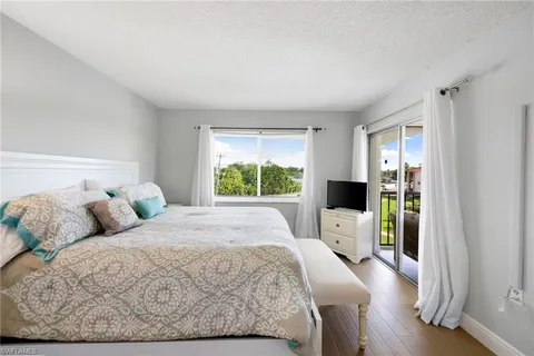 a bedroom with a large bed and a window