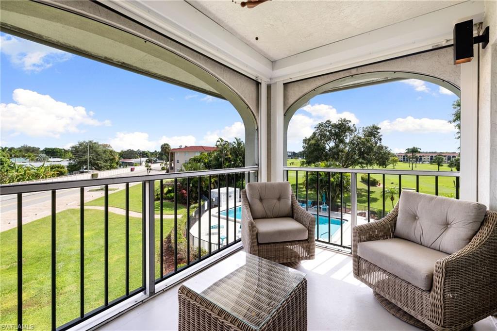5 High Point Circle West, Unit 307 Naples, FL 34103 - Photo 21 of 31 a balcony with furniture and a view of balcony