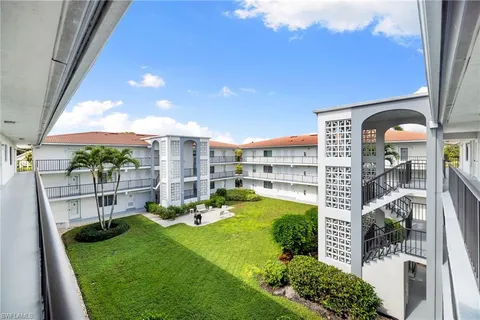 a view of a swimming pool with a garden and plants