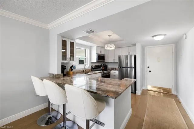 a large kitchen with a table and chairs