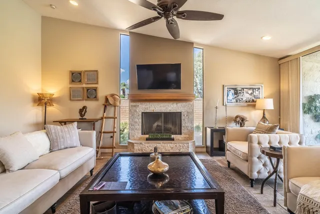 a living room with furniture and a chandelier
