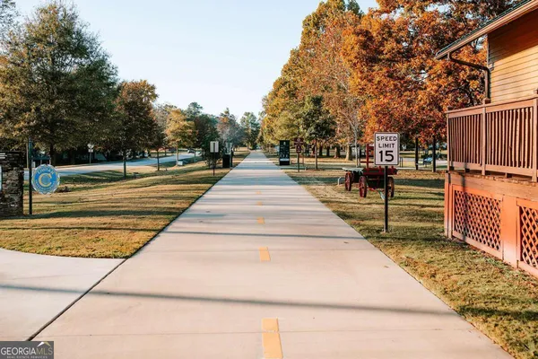 a view of a field with trees in background