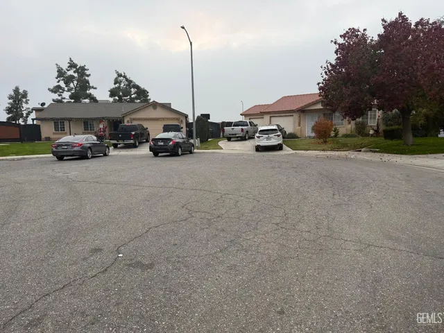 a car parked in front of a house with a cars parked