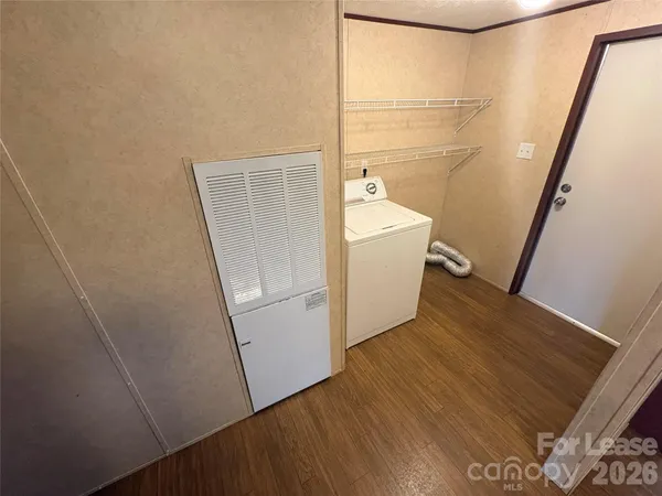 a view of washer and dryer with wooden floor