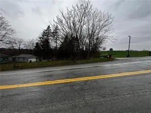 a view of a balcony with a yard