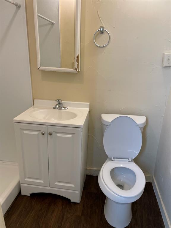 617 West Gandy Street Denison, TX 75020 - Photo 13 of 14 a bathroom with a toilet sink and mirror