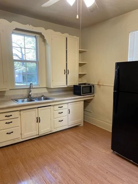 617 West Gandy Street Denison, TX 75020 - Photo 5 of 14 a kitchen with granite countertop white cabinets and a sink