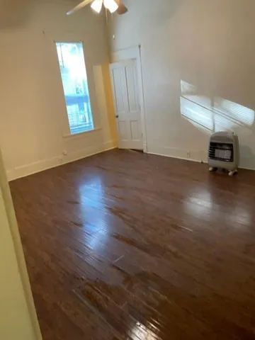 wooden floor in an empty room with a window