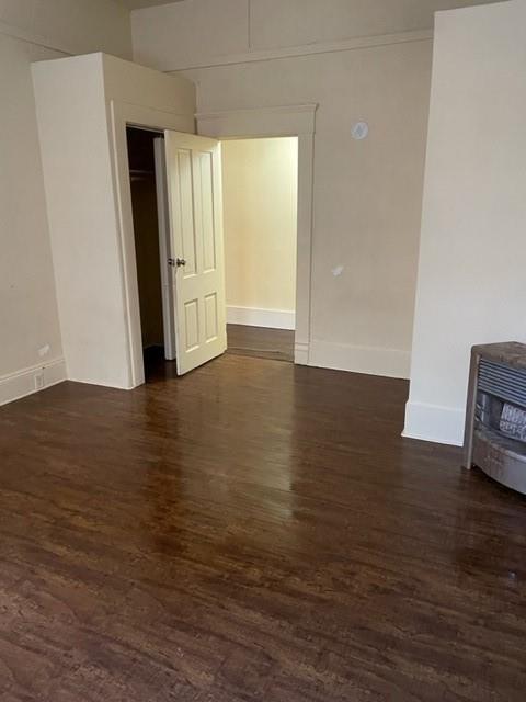 617 West Gandy Street Denison, TX 75020 - Photo 8 of 14 an empty room with wooden floor and windows