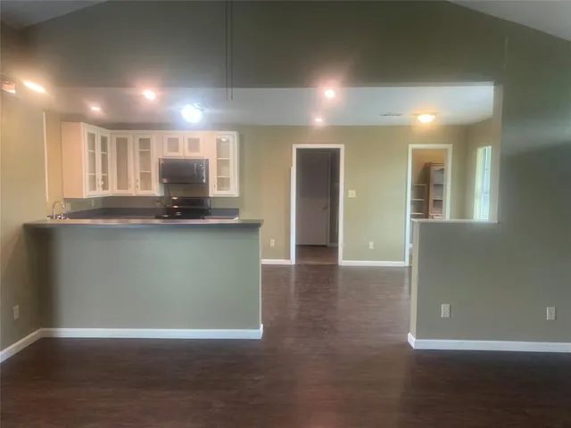 a view of kitchen with refrigerator and window