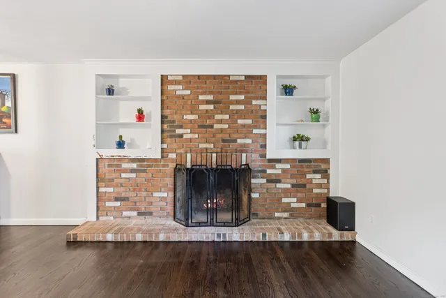a view of a fireplace with wooden floor