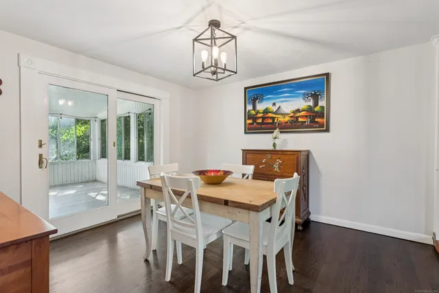 a view of a dining room with furniture wooden floor and a chandelier