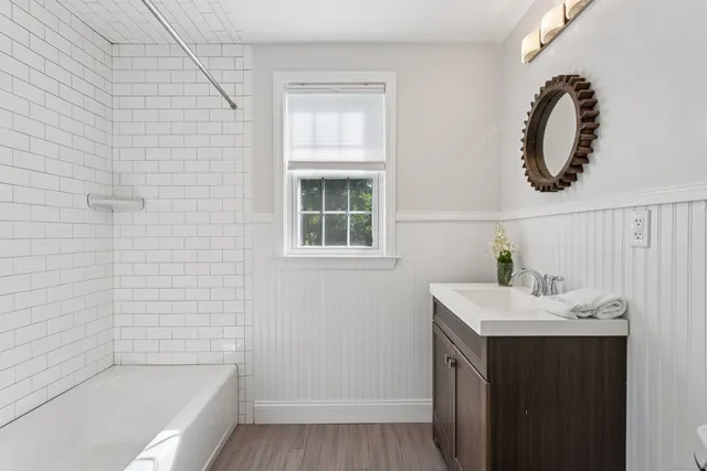 a bathroom with a sink a toilet and tub