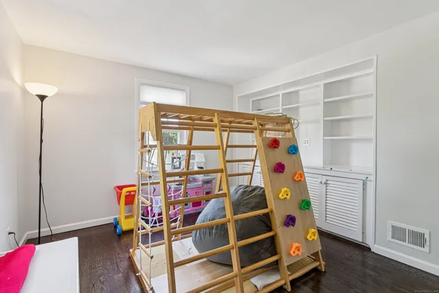 a view of a room with wooden floor and furniture