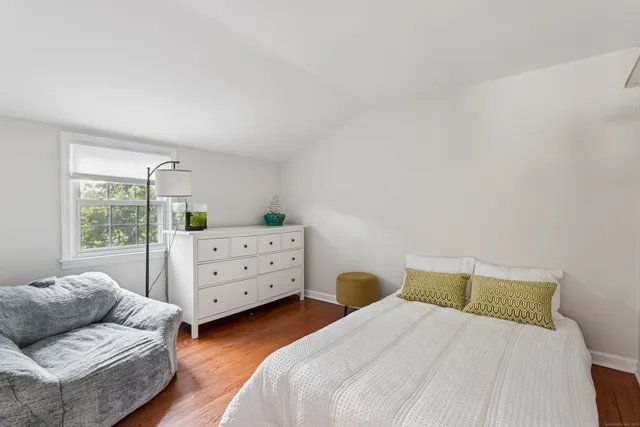 a bedroom with two beds and a window