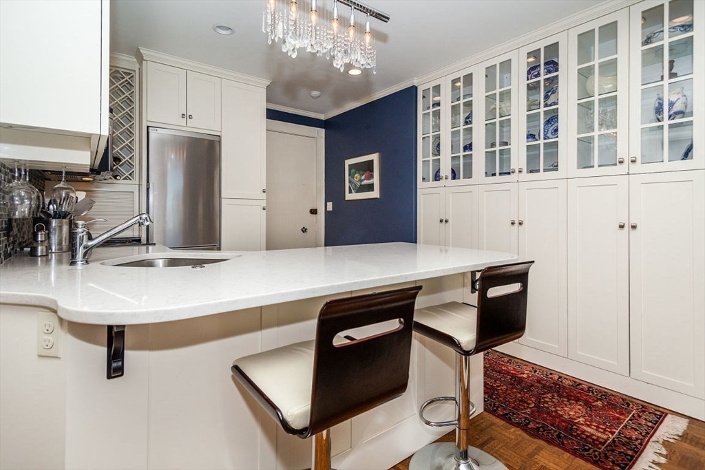21 Beacon Street, Unit 5I Boston, MA 02108 - Photo 4 of 13 a kitchen with a sink cabinets and window