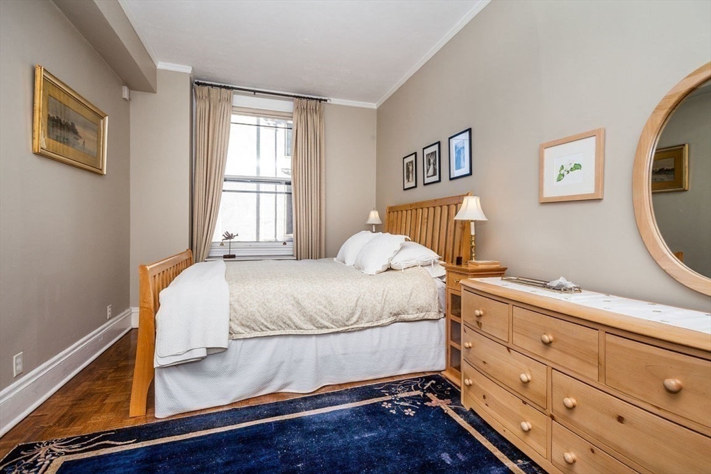 21 Beacon Street, Unit 5I Boston, MA 02108 - Photo 5 of 13 a bedroom with a bed and a window