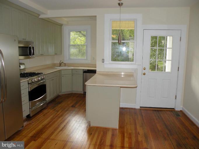 629 Deepdene Road Baltimore, MD 21210 - Photo 12 of 13 a kitchen with a stove a sink and a microwave