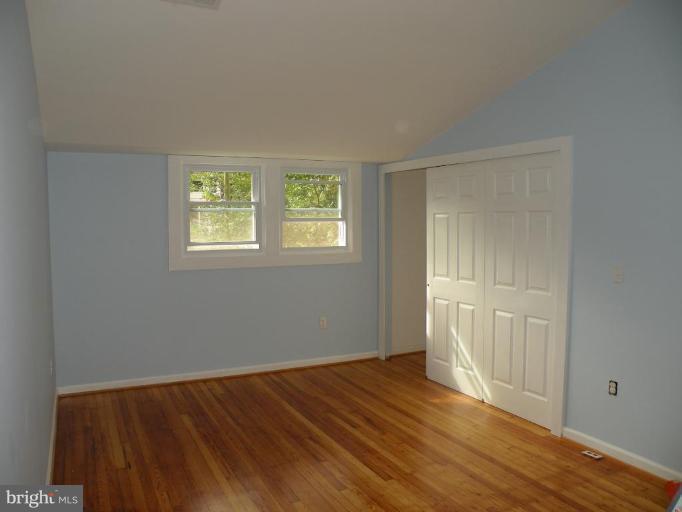 629 Deepdene Road Baltimore, MD 21210 - Photo 4 of 13 a view of an empty room with wooden floor and a window