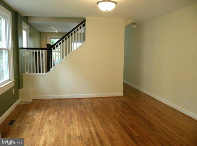 629 Deepdene Road Baltimore, MD 21210 - Photo 8 of 13 a view of an empty room with wooden floor
