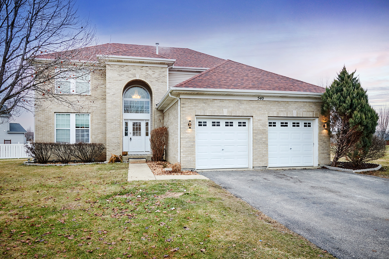 a front view of a house with a yard