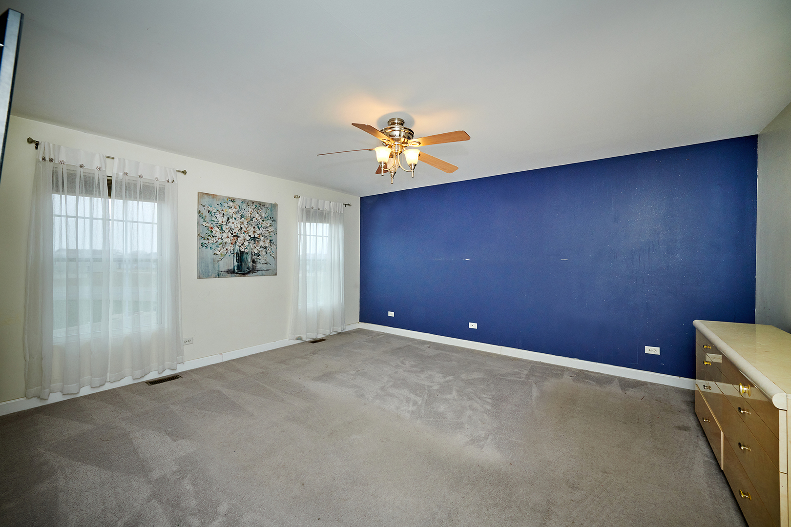 540 Wynbrooke Road Romeoville, IL 60446 - Photo 11 of 27 an empty room with windows and a chandelier fan