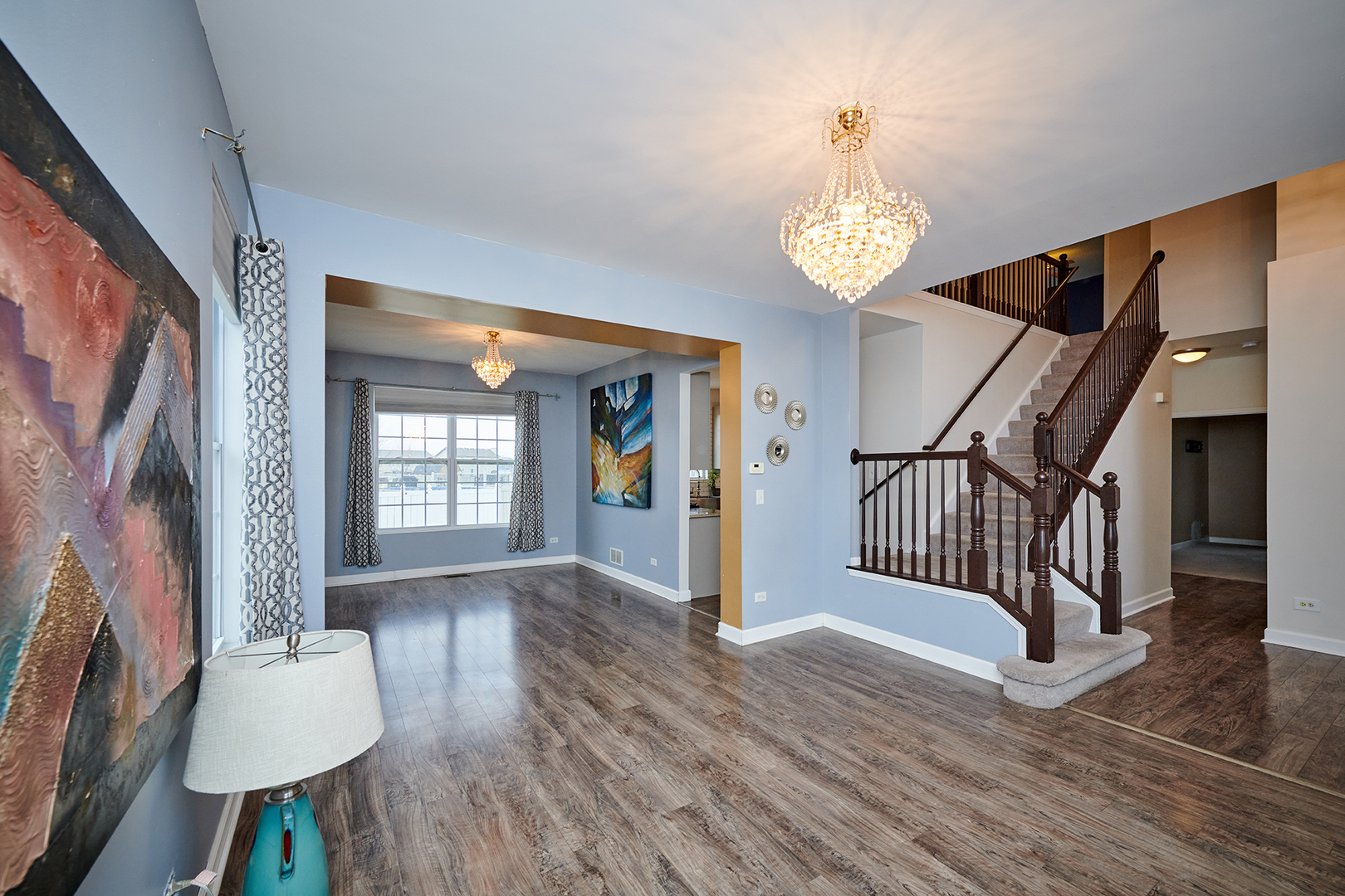 540 Wynbrooke Road Romeoville, IL 60446 - Photo 2 of 27 a view of an entryway with wooden floor and a chandelier