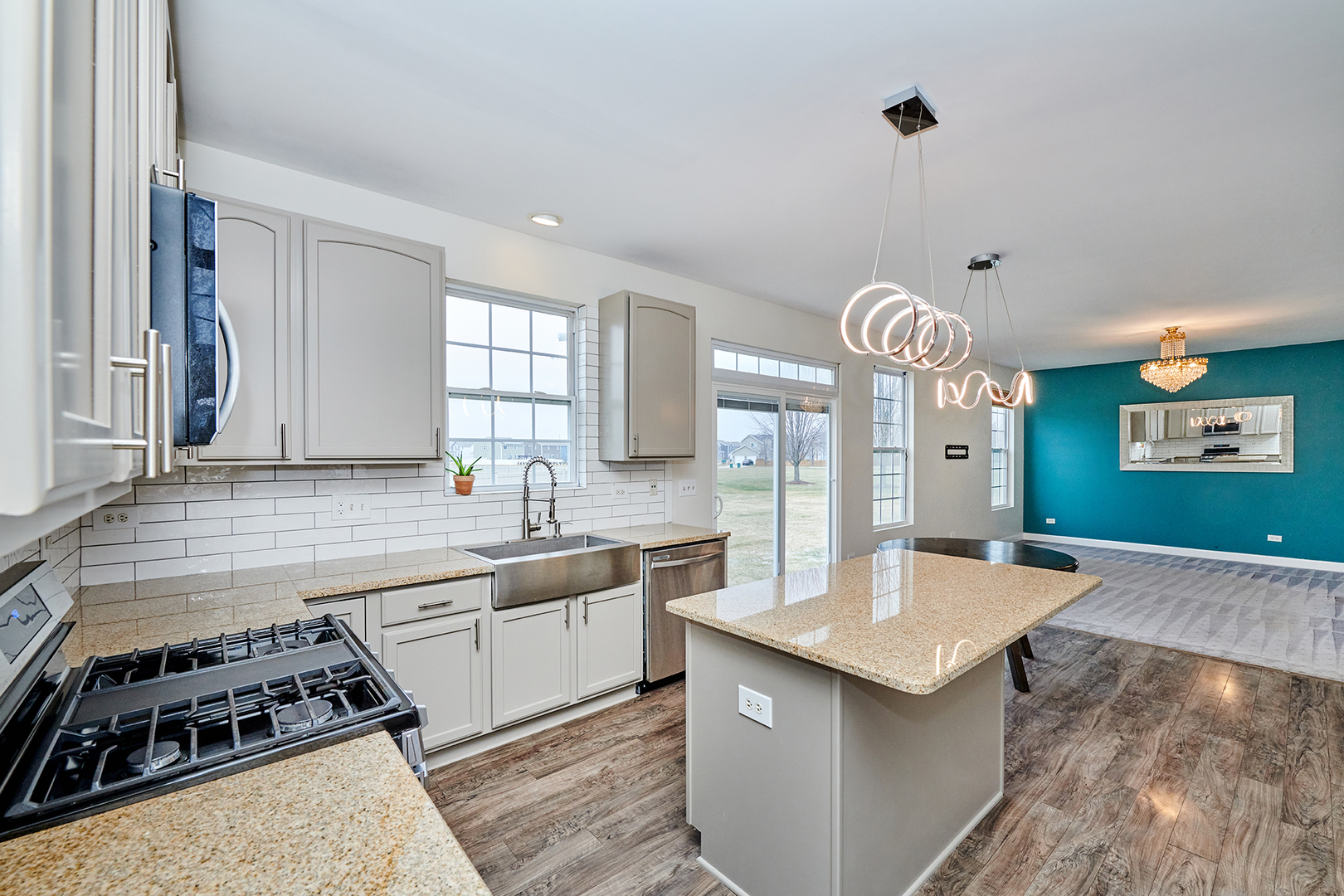 540 Wynbrooke Road Romeoville, IL 60446 - Photo 5 of 27 a kitchen with stainless steel appliances a sink a stove top oven and cabinets