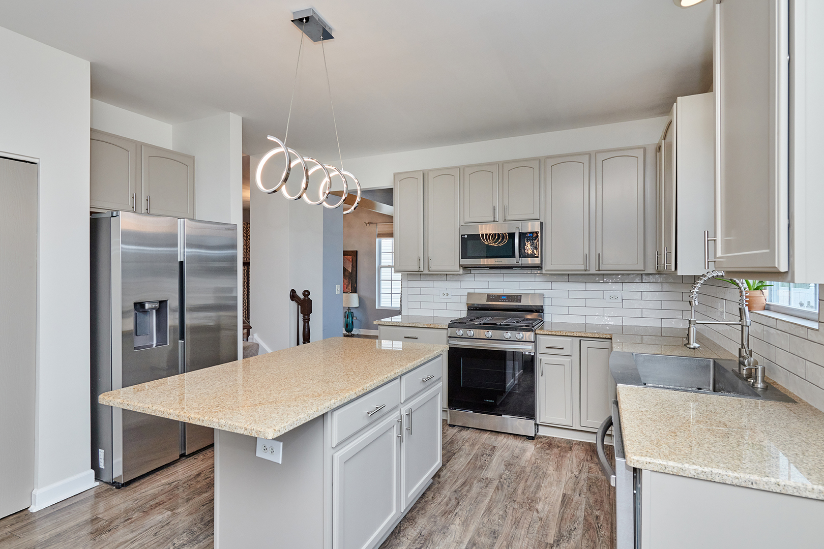 540 Wynbrooke Road Romeoville, IL 60446 - Photo 6 of 27 a kitchen with a sink a microwave a refrigerator and cabinets