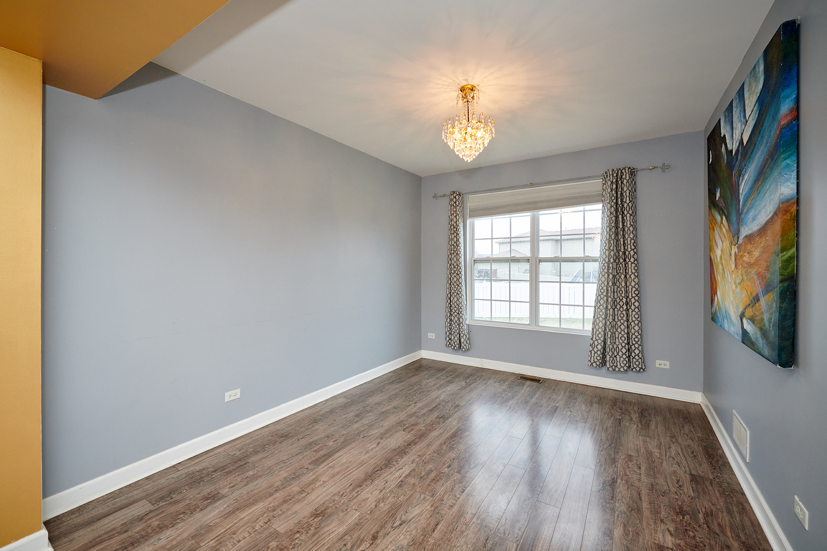 540 Wynbrooke Road Romeoville, IL 60446 - Photo 9 of 27 a view of an empty room with wooden floor and a window