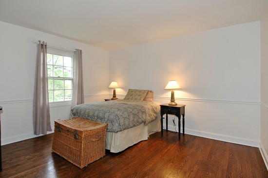69 Round Barn Road Barrington Hills, IL 60010 - Photo 11 of 15 a spacious bedroom with a bed and wooden floor