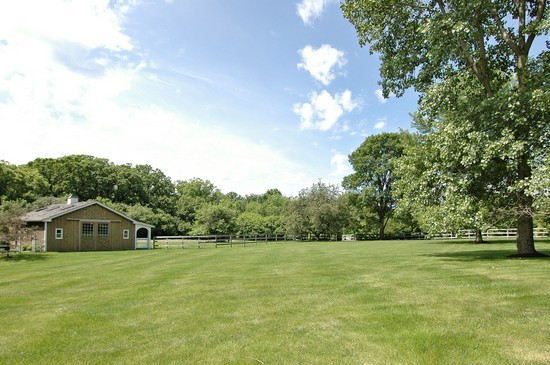 69 Round Barn Road Barrington Hills, IL 60010 - Photo 15 of 15 a front view of a house with a yard