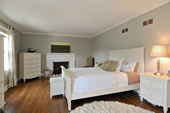 69 Round Barn Road Barrington Hills, IL 60010 - Photo 9 of 15 a bedroom with a bed and a fireplace