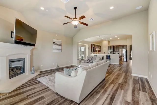 a living room with fireplace furniture and a flat screen tv