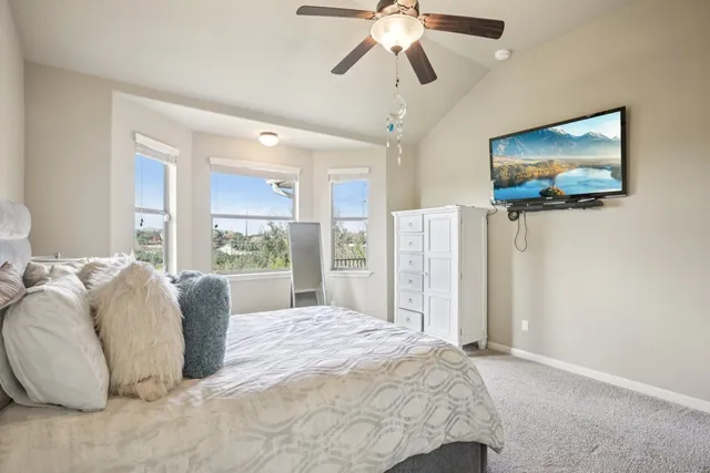 a bedroom with a large bed and a flat screen tv