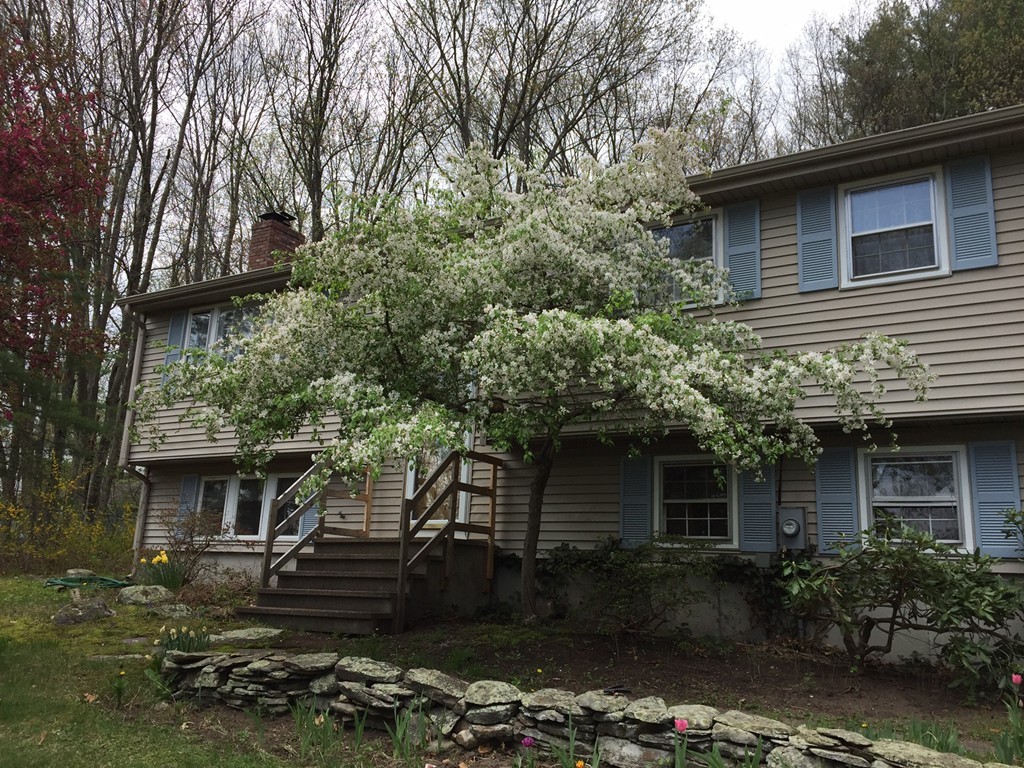 39 Old Bolton Road Hudson, MA 01749 - Photo 1 of 19 a front view of a house with a garden