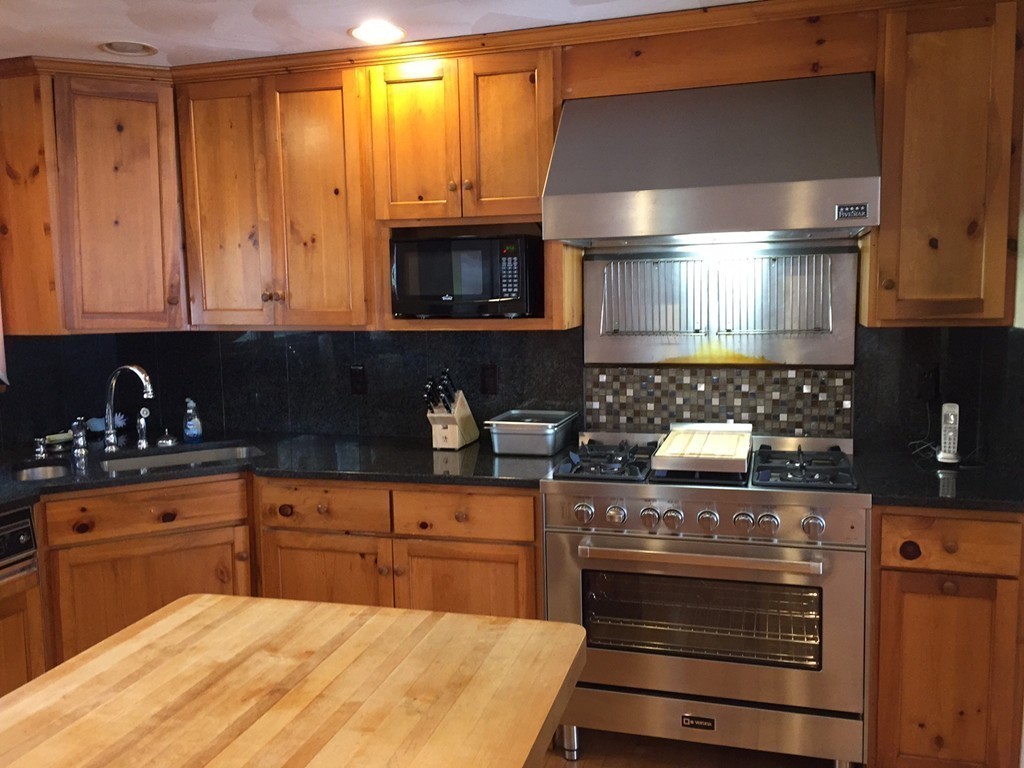 39 Old Bolton Road Hudson, MA 01749 - Photo 5 of 19 a kitchen with stainless steel appliances granite countertop a stove a sink and a microwave