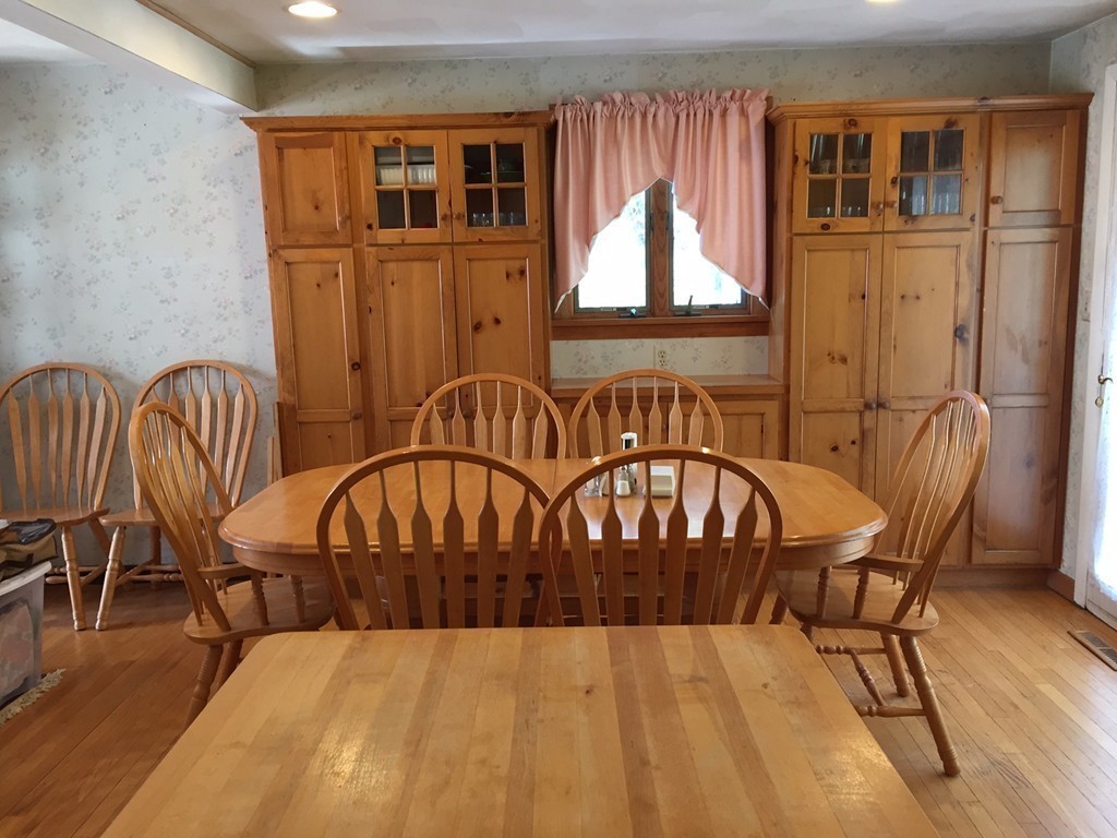 39 Old Bolton Road Hudson, MA 01749 - Photo 7 of 19 a view of a chairs and a table in a balcony