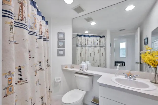 a bathroom with a double vanity sink toilet and shower