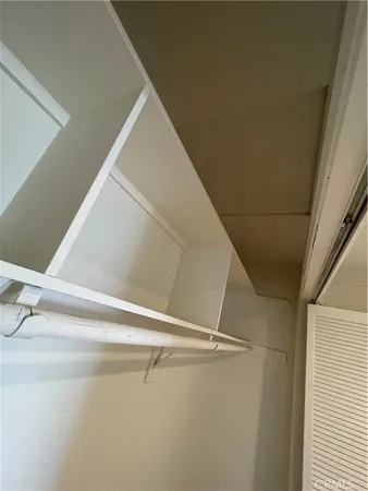 a view of a room with shelf on the wall
