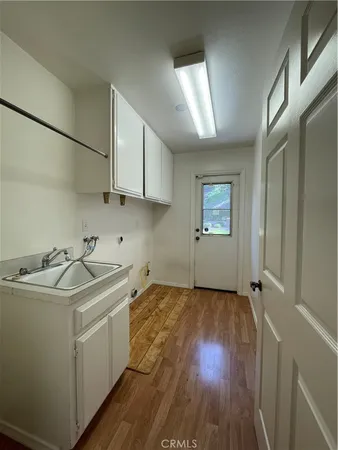 a view of a room with wooden floor