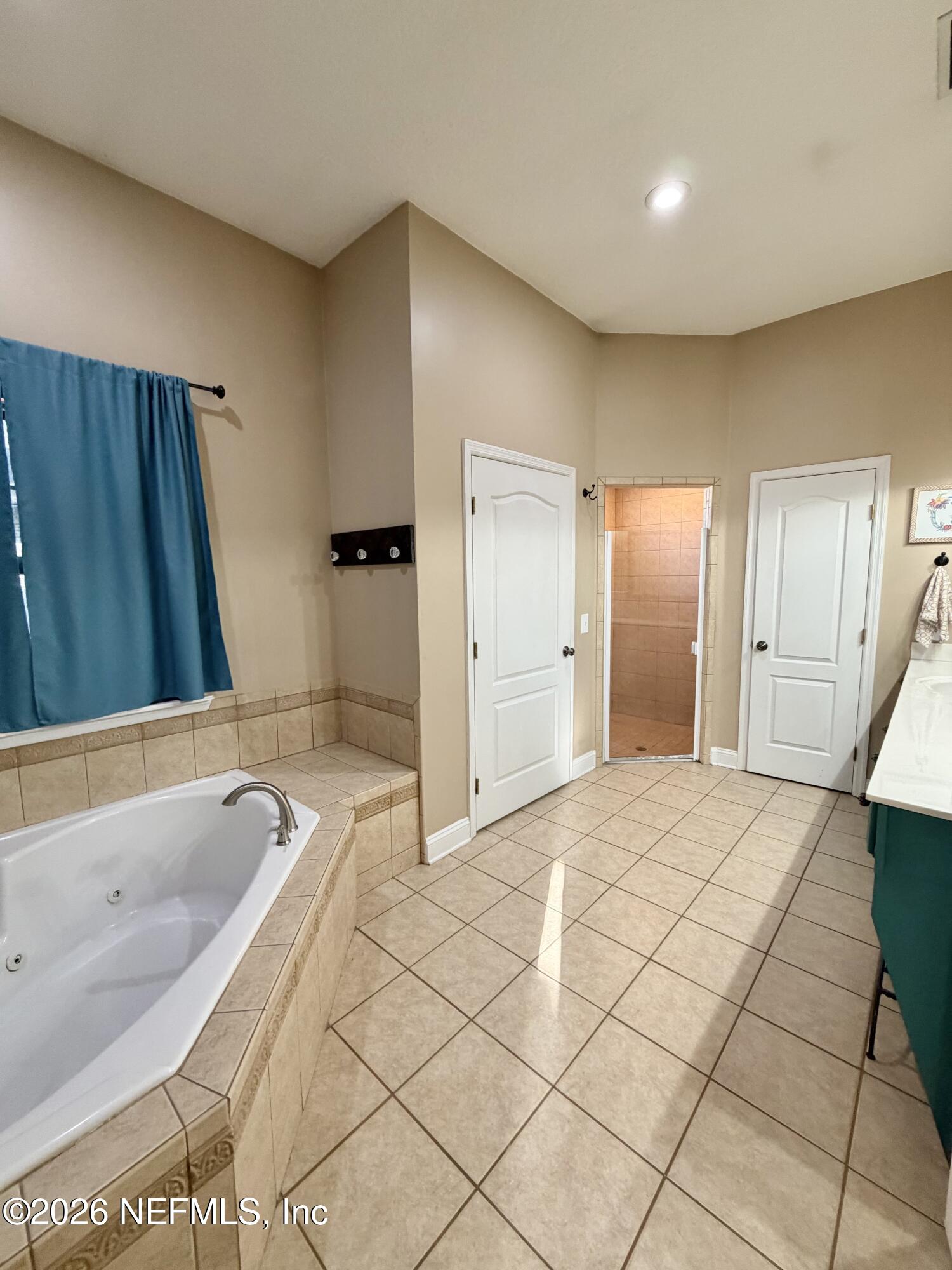 6116 Copper Drive Macclenny, FL 32063 - Photo 15 of 21 a bathroom with a bathtub and a shower