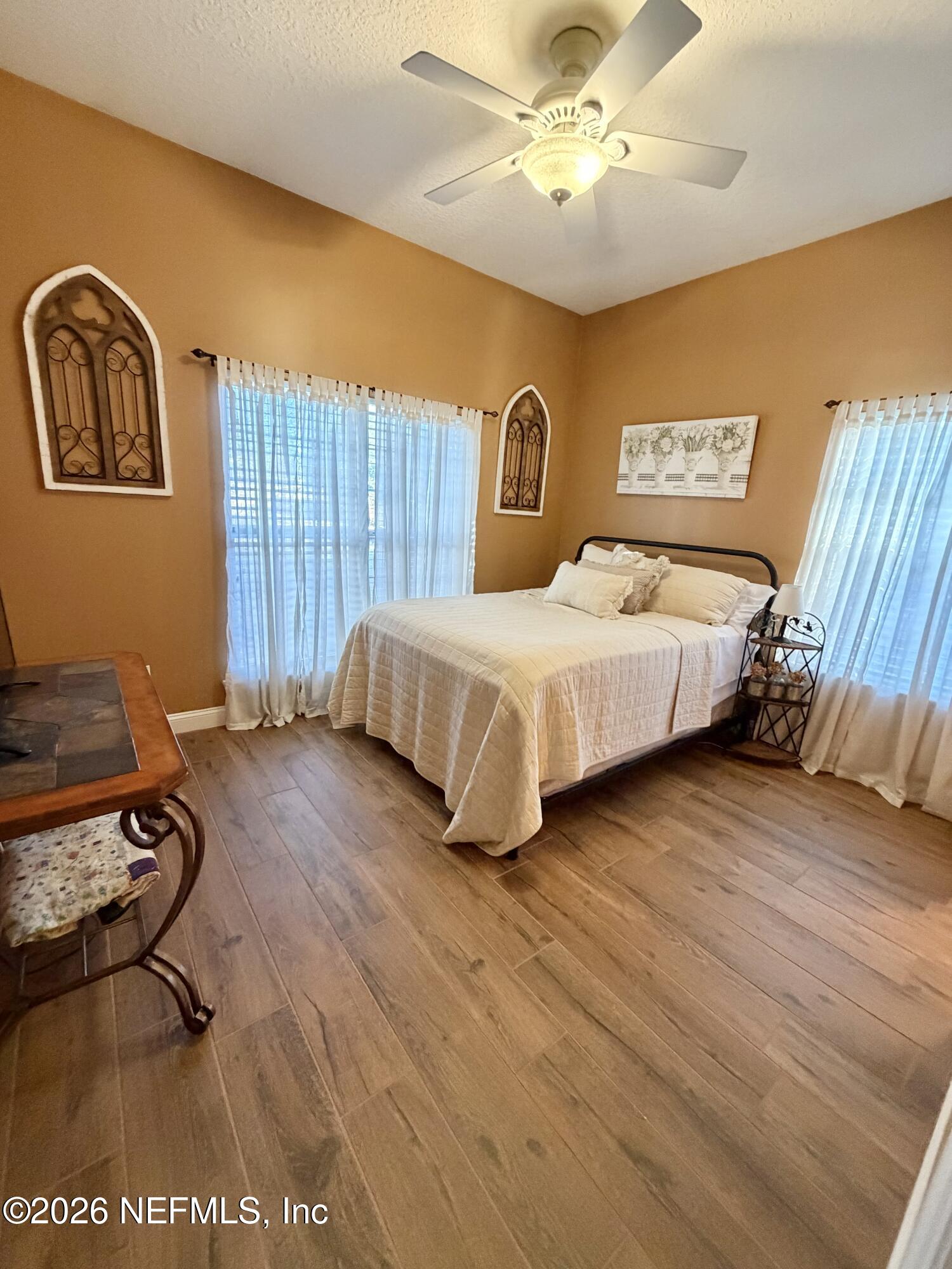 6116 Copper Drive Macclenny, FL 32063 - Photo 18 of 21 a bedroom with a bed and wooden floor