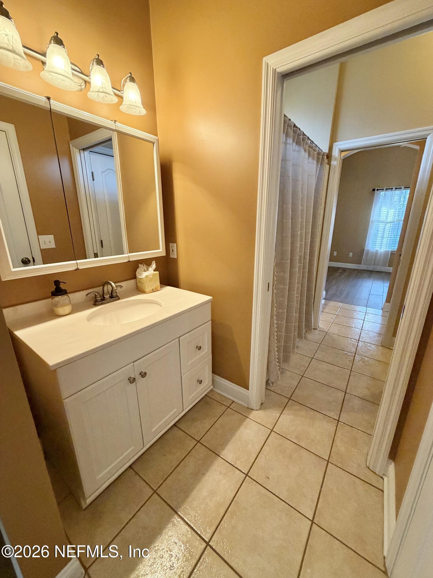 6116 Copper Drive Macclenny, FL 32063 - Photo 20 of 21 a spacious bathroom with a mirror sink and vanity