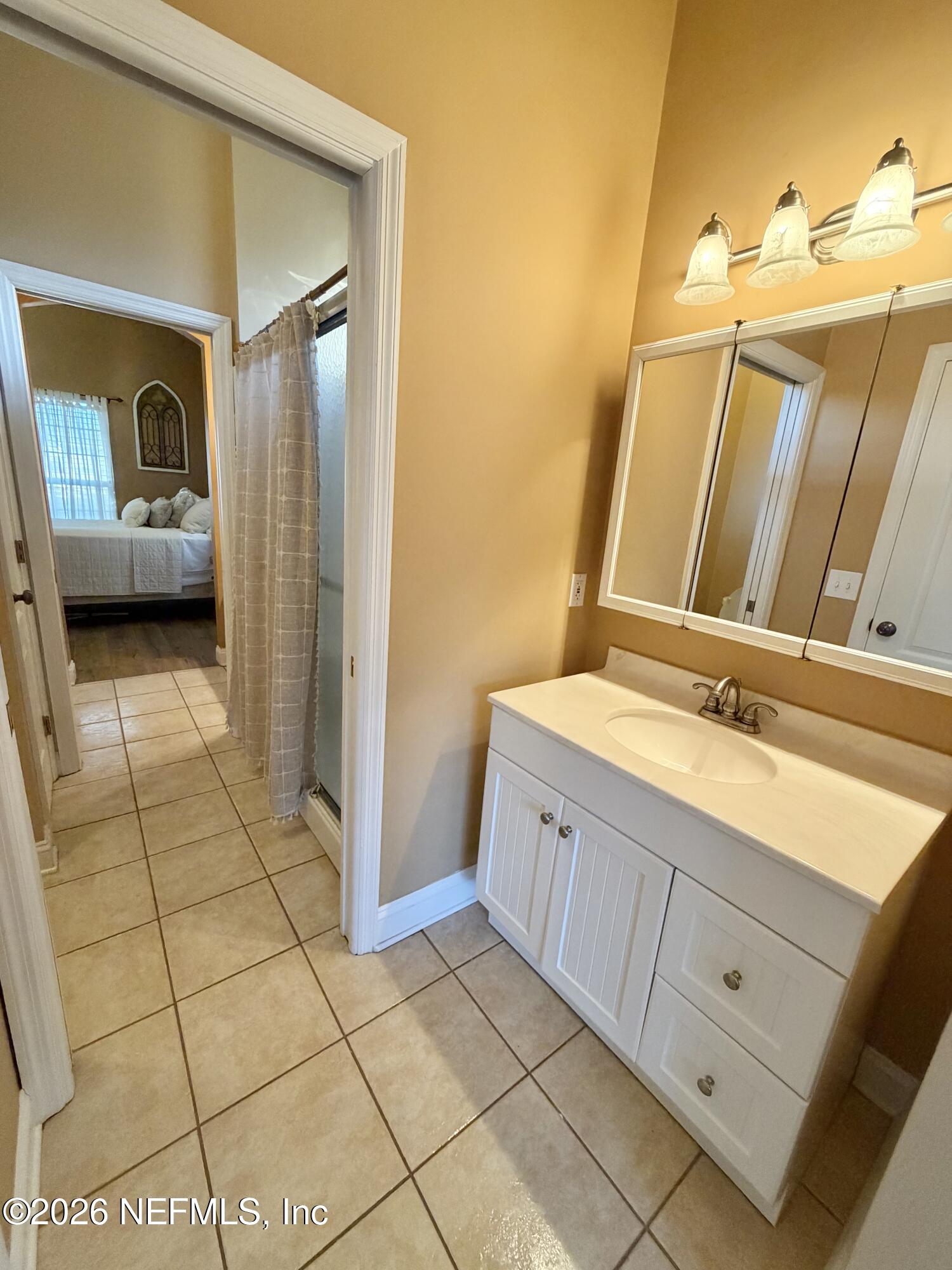 6116 Copper Drive Macclenny, FL 32063 - Photo 21 of 21 a bathroom with a double vanity sink and a mirror