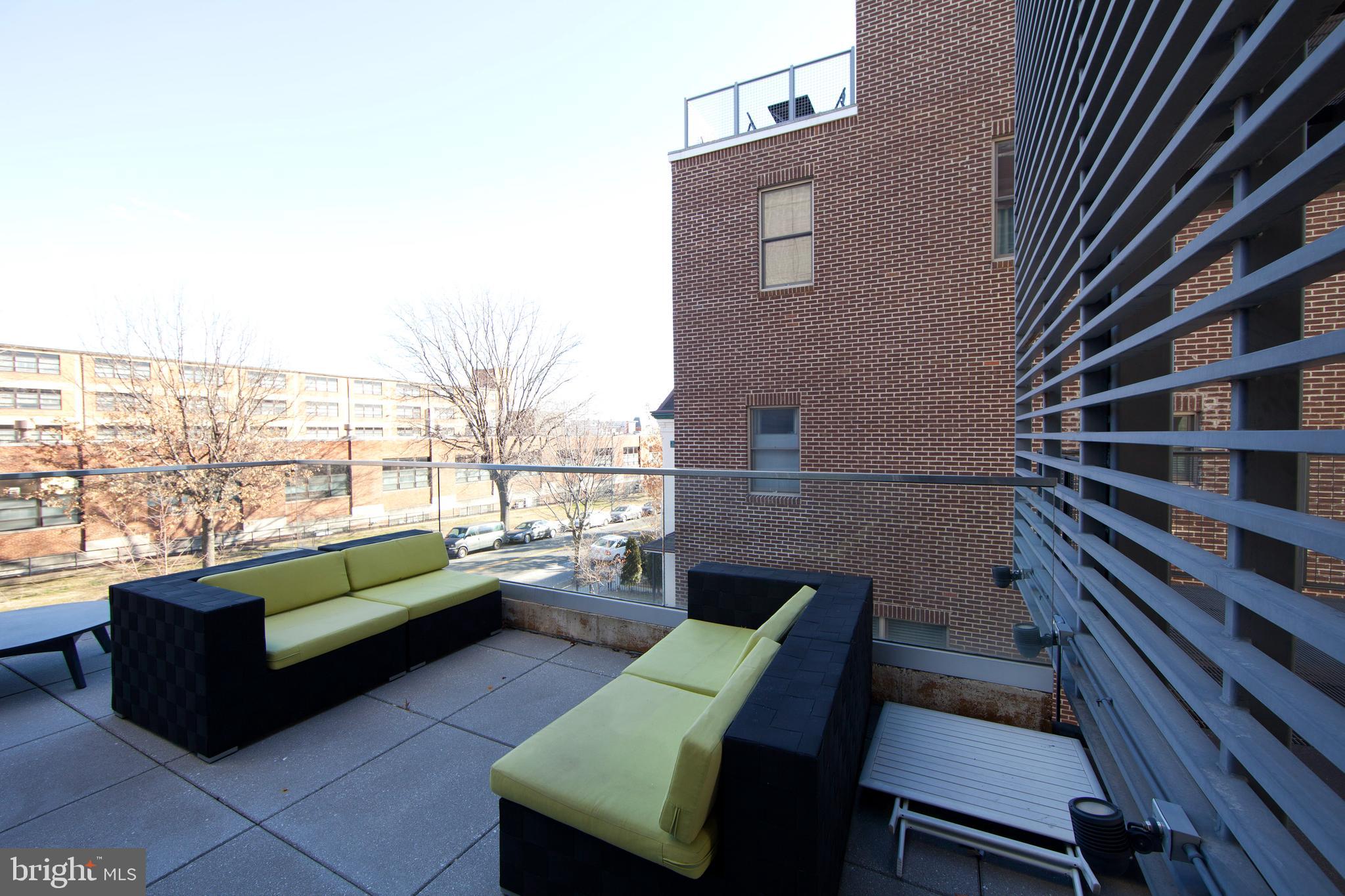 2250 11th Street Northwest, Unit 304 Washington, DC 20001 - Photo 14 of 17 a balcony with couple of chairs and a couch