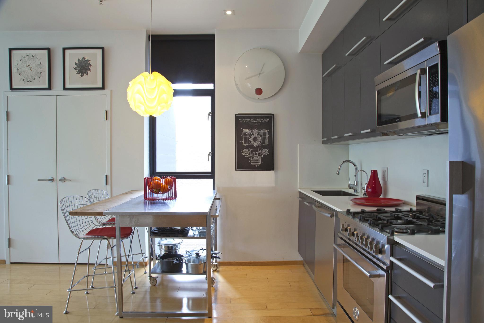 2250 11th Street Northwest, Unit 304 Washington, DC 20001 - Photo 2 of 17 a kitchen with stainless steel appliances granite countertop a stove and a sink