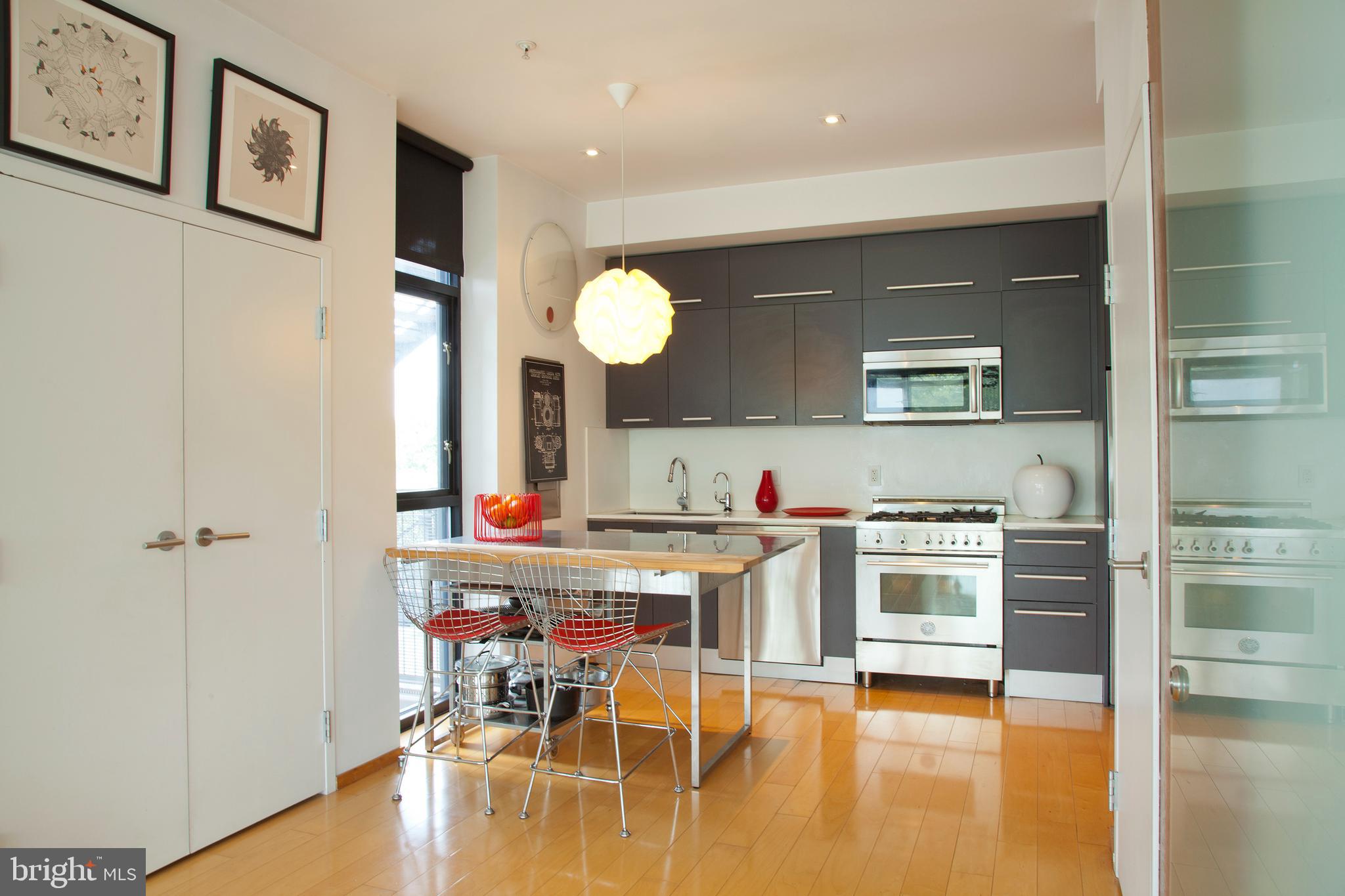 2250 11th Street Northwest, Unit 304 Washington, DC 20001 - Photo 4 of 17 a kitchen with stainless steel appliances granite countertop a refrigerator and a stove top oven