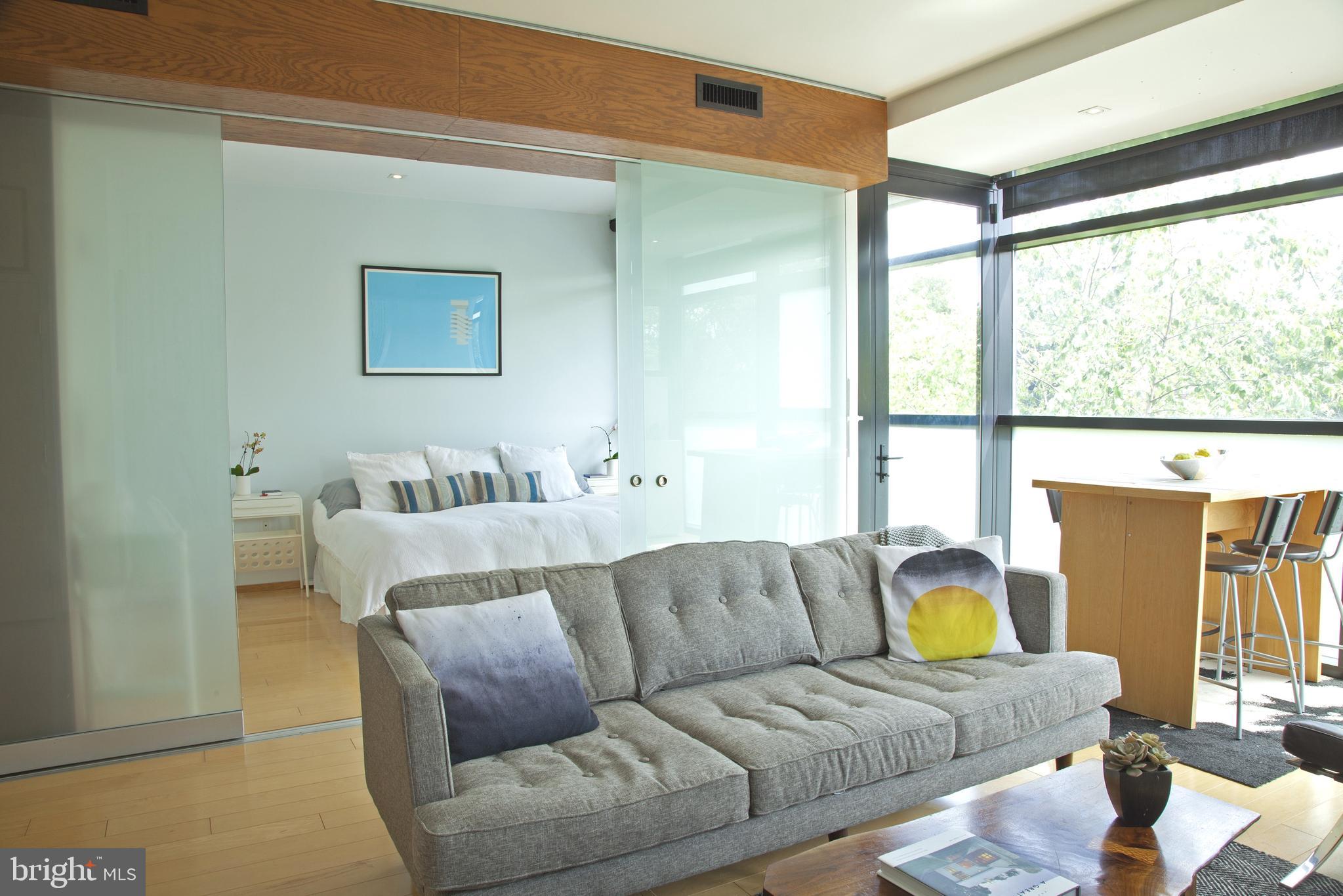 2250 11th Street Northwest, Unit 304 Washington, DC 20001 - Photo 6 of 17 a living room with furniture and a large window
